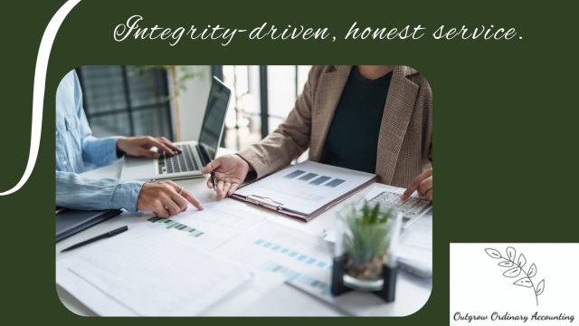 Two-professionals-review-financial-charts-and-documents-at-a-desk-with-a-laptop,-symbolizing-integrity-driven,-honest-accounting-service-by-Outgrow-Ordinary-Accounting.